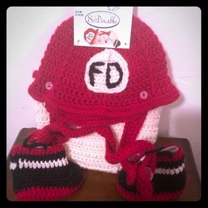 Newborn crocheted fireman’s outfit.
